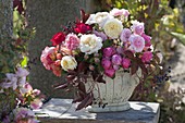 Mixed bouquet of roses in autumn: Rosa (roses) and Parthenocissus