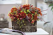 Autumn arrangement in bark-clad bowl