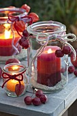 Old preserving jars as lanterns with homemade candles made from candle remnants