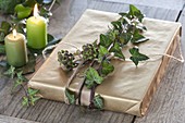 Book gift naturally wrapped with wrapping paper, decorated with tendril