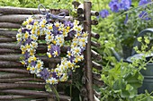 Heart-shaped wreath of camomile (Matricaria chamomilla) and flowers