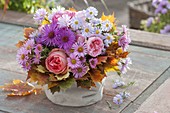 Small autumn bouquet with pink (roses), aster (autumn asters) and cuff