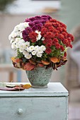 Tricolour bouquet of Chrysanthemum (autumn chrysanthemum) with wreath