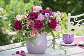 Pink (rose) bouquet in purple and pink in ceramic jug