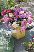 Mixed pink (rose) bouquet in a coffee tin as a vase