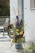 High arrangement of perennials and grasses on the doorstep
