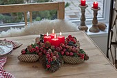 Pine cone star with fruits and berries as Advent wreath