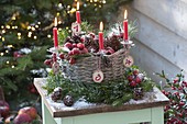 Basket filled with cones and malus as Advent wreath