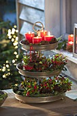 Advent decoration with candles and pear berries in metal tray