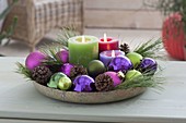 Bowl with candles, balls, cones, branches of pinus (pine)