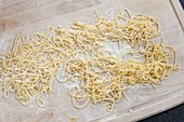 Homemade pasta on baking board