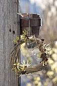 Wreath of winded grass, decorated with fragrant flowers