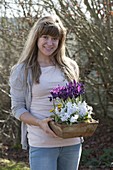 Woman wears clay bowl with Scilla mischtschenkoana (blue oysters)