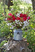 Red-white bouquet made of branches of Prunus, Malus