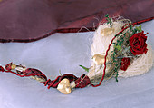 Heart made of wood wool, dried rose blossoms, ribbons and ivy twig