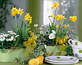 Easter table decoration with daffodils and daisies