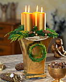Candles in a high container with floral foam as Advent arrangement