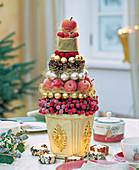 Pyramid of decorative berries, apples, balls, cones and angel hair