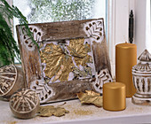 Picture frame with leaves sprayed with gold