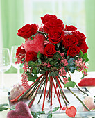 Bouquet of red roses, hedera (ivy) and red rods