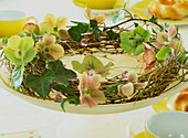 Wreath of willow twigs decorated with flowers of the spring rose