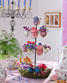 Wire rack with painted eggs, pansies (Viola)