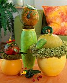 Pumpkin faces made of ornamental pumpkins, cucumbers, seeds, Tropaeolum flowers