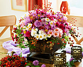 Autumn bouquet with various autumn asters and rose hips