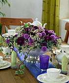 Table decoration with Callistephus (summer aster), Aster 'Marie Ballard', lavender branch