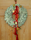 Door wreath made of Iceland moss, stars and ribbons