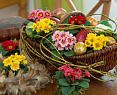 Easter basket with primroses and Easter eggs