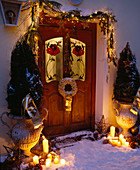 House entrance Christmassy decorated with amphorae, branches