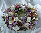 Plate wreath with flowers of violets, spring star, ribbon flower and gorse