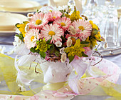 Bellis (daisies), Euphorbia (spurge), Pulmonaria (lungwort), feathers