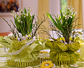 Convallaria majalis (Lily of the Valley), Cytisus (broom branches), pots with paper