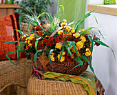 Basket with roses, helenium (sunflower), grasses, flowers