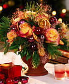 Christmas branches arrangement, rose petals and balls
