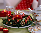 Star candle in a plate wreath made of Nordmann fir, lime slices and balls