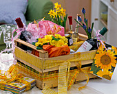 Wooden fruit box as a gift basket, Primula (primrose), Muscari