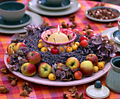 Table wreath with ornamental apples, lavender and candle