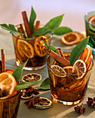 Glasses with Citrus sinensis and limonia (orange and lime slices), orange leaf