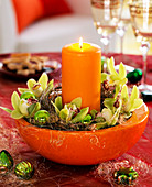 Cup with orchid flowers and candle