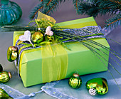Gift in May green with Jasminum (jasmine twigs), Cupressus (cypress), tree ornaments