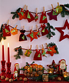 Advent calendar made of small bags, stars and parcels of felt, with clamp