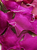 Stars sewn from felt as Christmas tree decorations, purple-pink