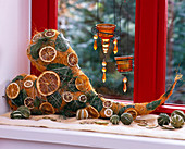 Orange sisal heart decorated with citrus (orange and lime slices), leaves