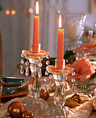 Salmon-coloured candles in glass candle holders Hippeastrum (salmon-coloured amaryllis), B