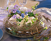 Glass bowl with twigs as nest