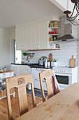 Old chairs at table in country-house kitchen