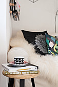 Teacup and books on stool next to sofa